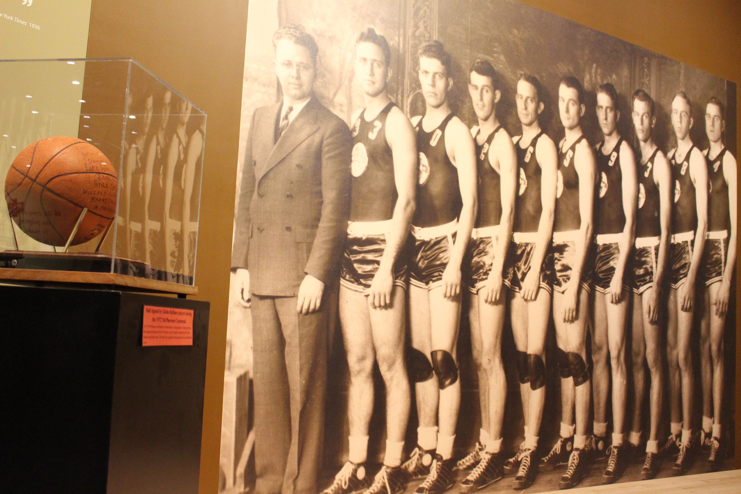 Life-size photo mural depicting 7 members of the 1936 Olympic Basketball Team with a signed basketba