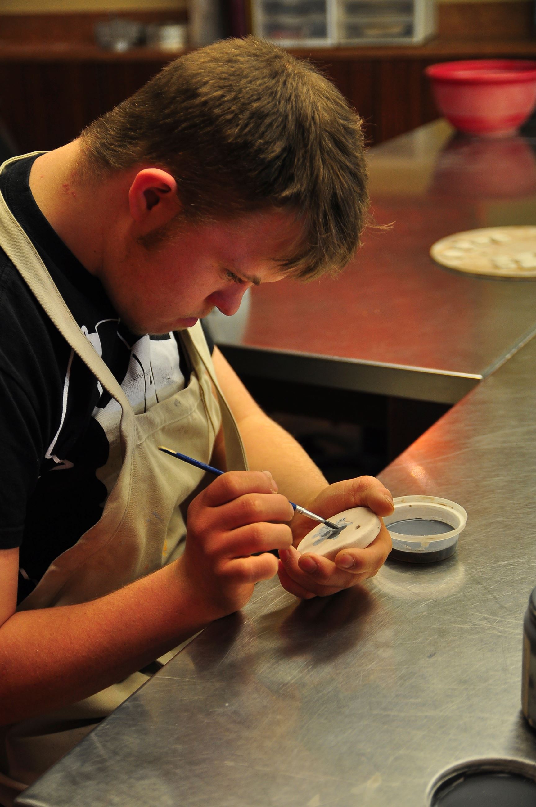 An artist at The Clayworks studio in McPherson works on a pottery project